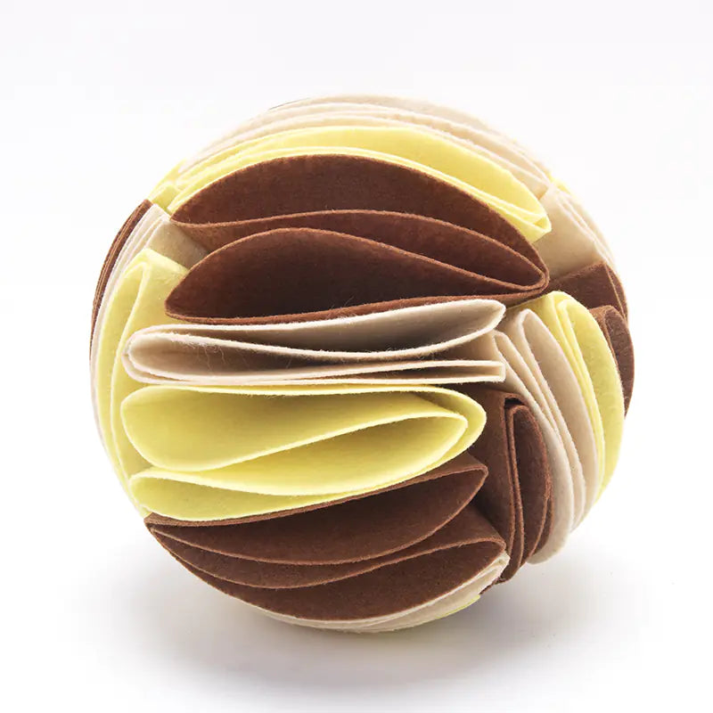 Beige, brown and yellow folded snuffle ball on a white background.