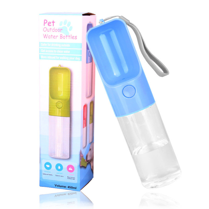 Blue 450 mL dog travel water bottle with built-in drinking trough, shown beside its packaging.
